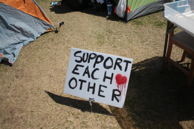 A sign reading "Support Each Other" on the Tivoli Quad on May 16, 2024