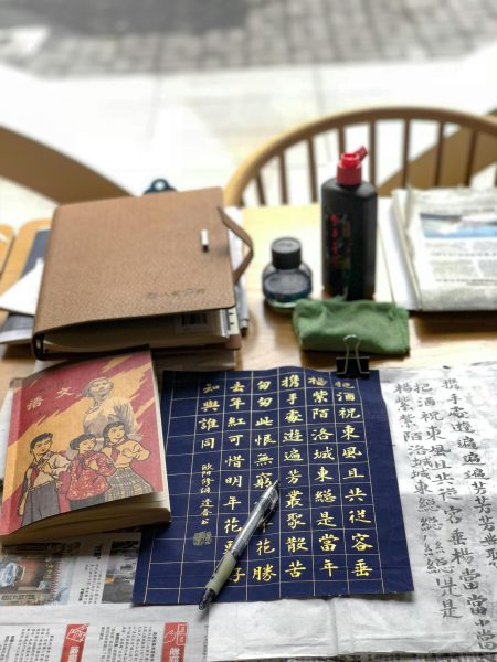 Chinese book and kanji on a desk.