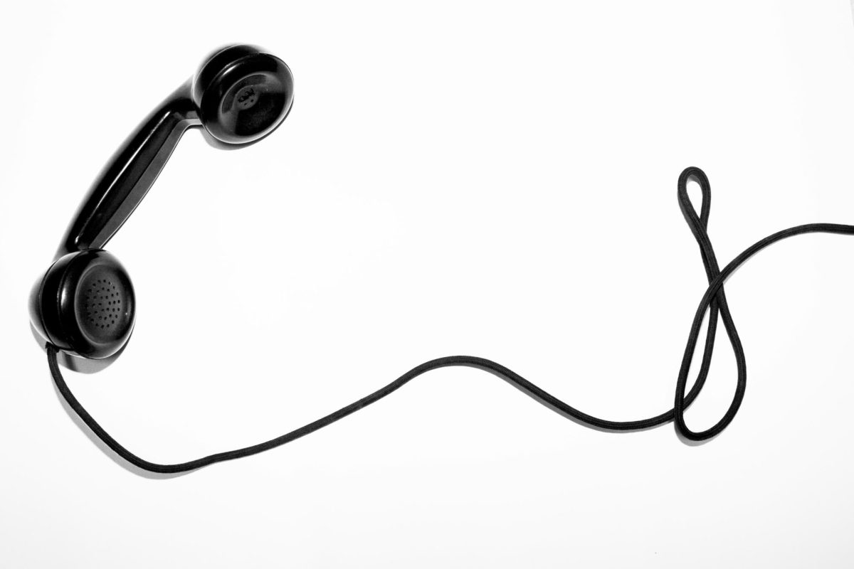 A black corded telephone on a white background.