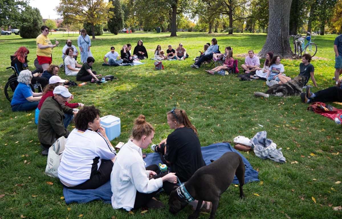 Attendees gather to eat pudding in Cheeseman Park