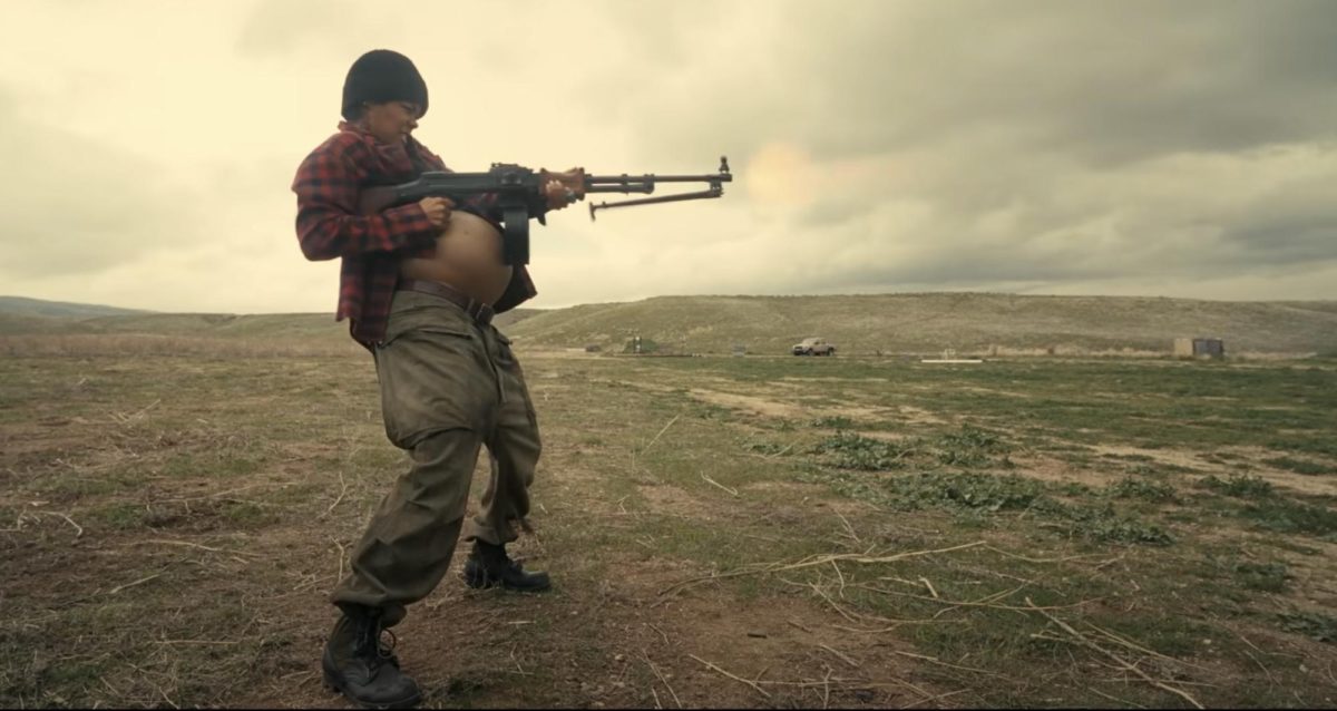 Teyana Taylor pictured with a machine gun 
Photo courtesy of YouTube 