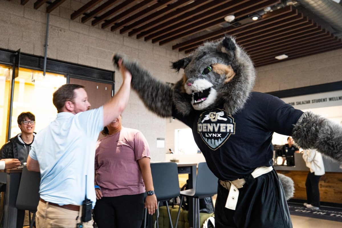 [PHOTO] Milo high-fiving person in Wellness Center 