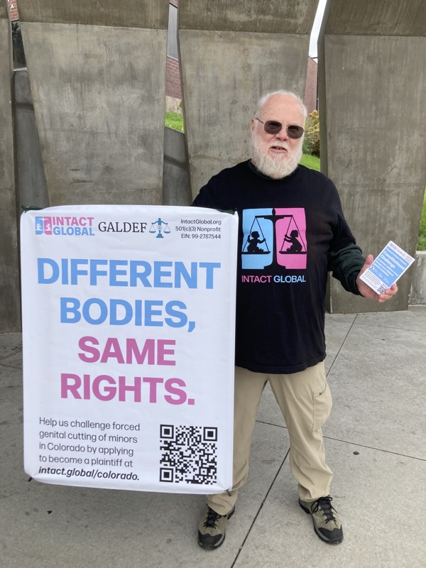 [PHOTO] Activist Dan Strandjord with a sign that read "DIFFERENT BODIES SAME RIGHTS"
